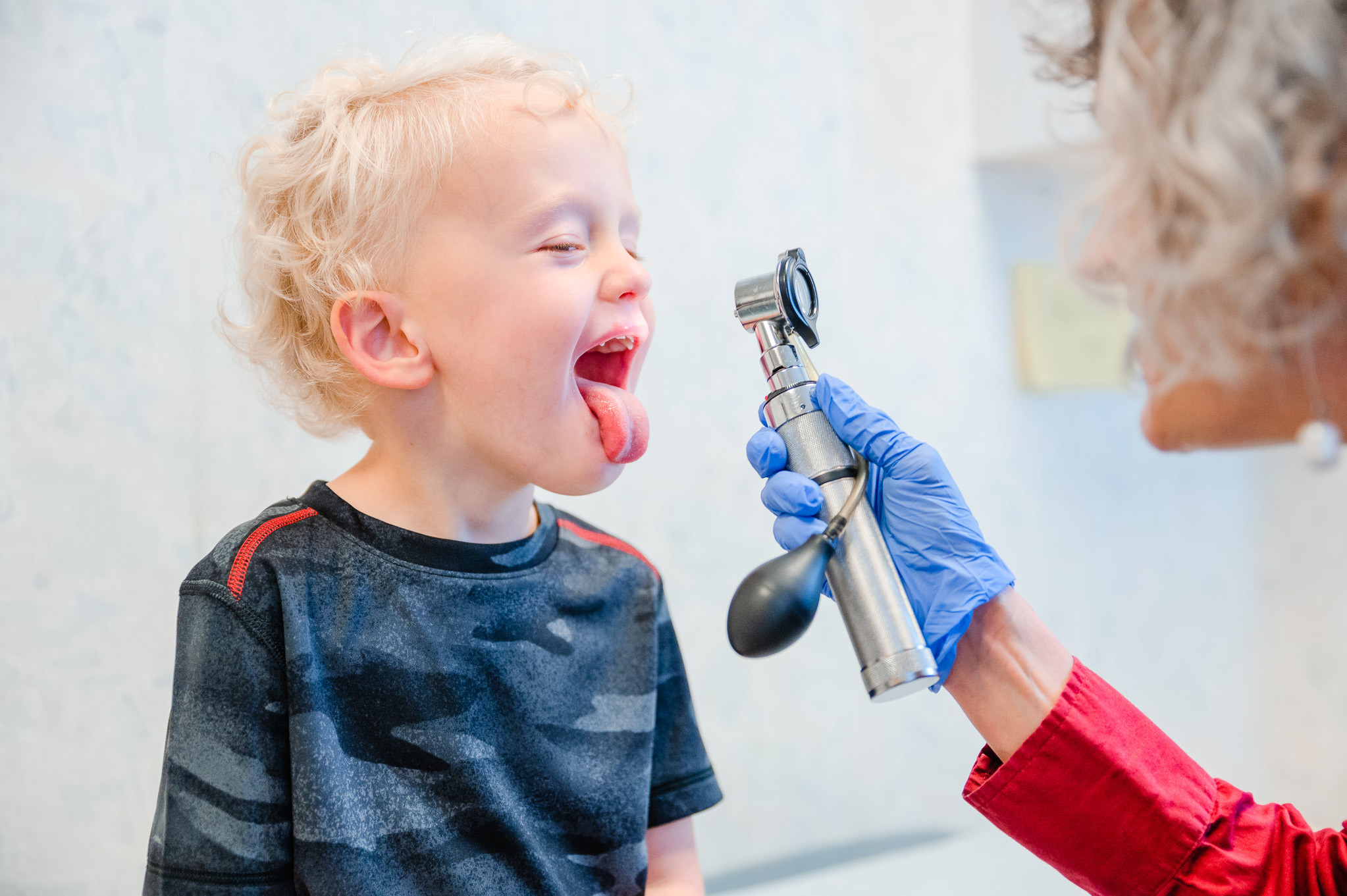 a boy getting his throat examined